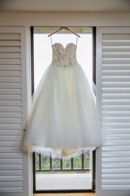 Full-skirt wedding gown hanging with room to spare in a wide gusseted garment bag