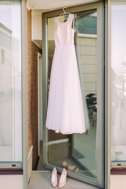 Personalized embroidered bridal garment bag hanging on a door for getting-ready photos