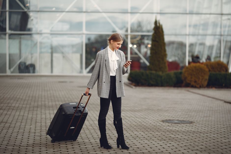 Bride carrying a waterproof wedding dress garment bag through a travel hub