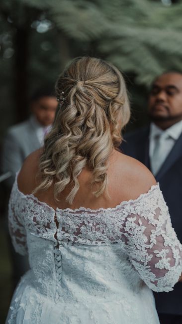 Bride wearing a lace bolero shrug over a wedding gown
