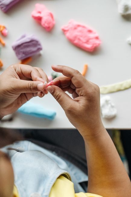 Children playing with modeling dough at a wedding craft table