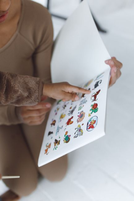 Child playing with a reusable sticker book at a wedding