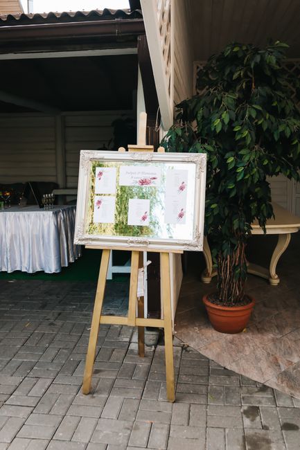 Brass tabletop easel holding a wedding bar sign