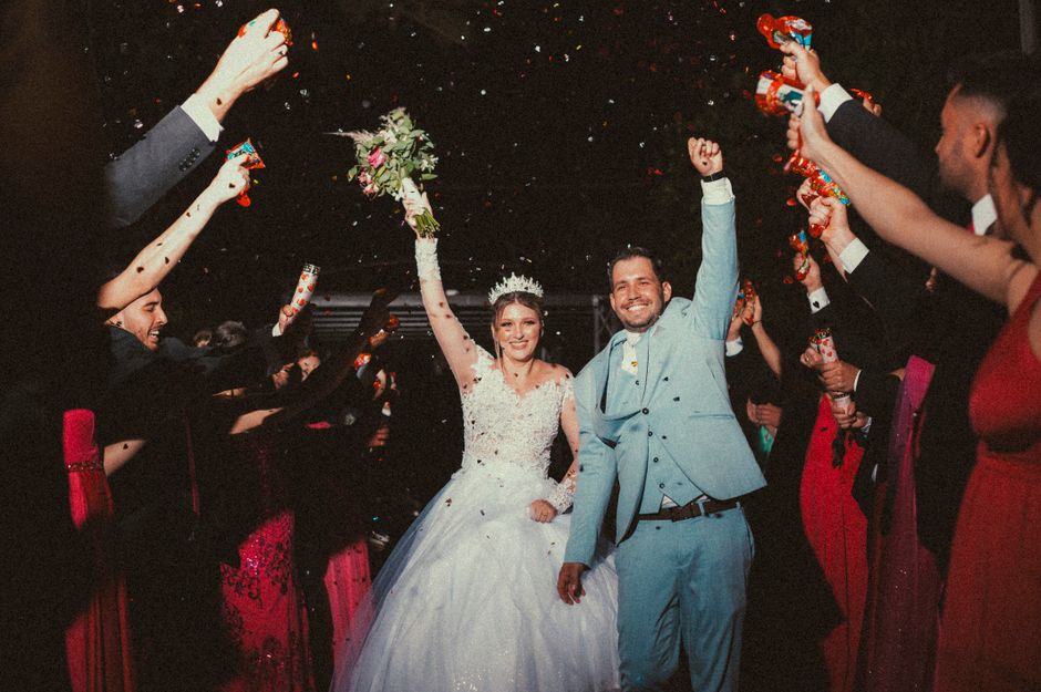 guests firing biodegradable confetti poppers at a wedding exit