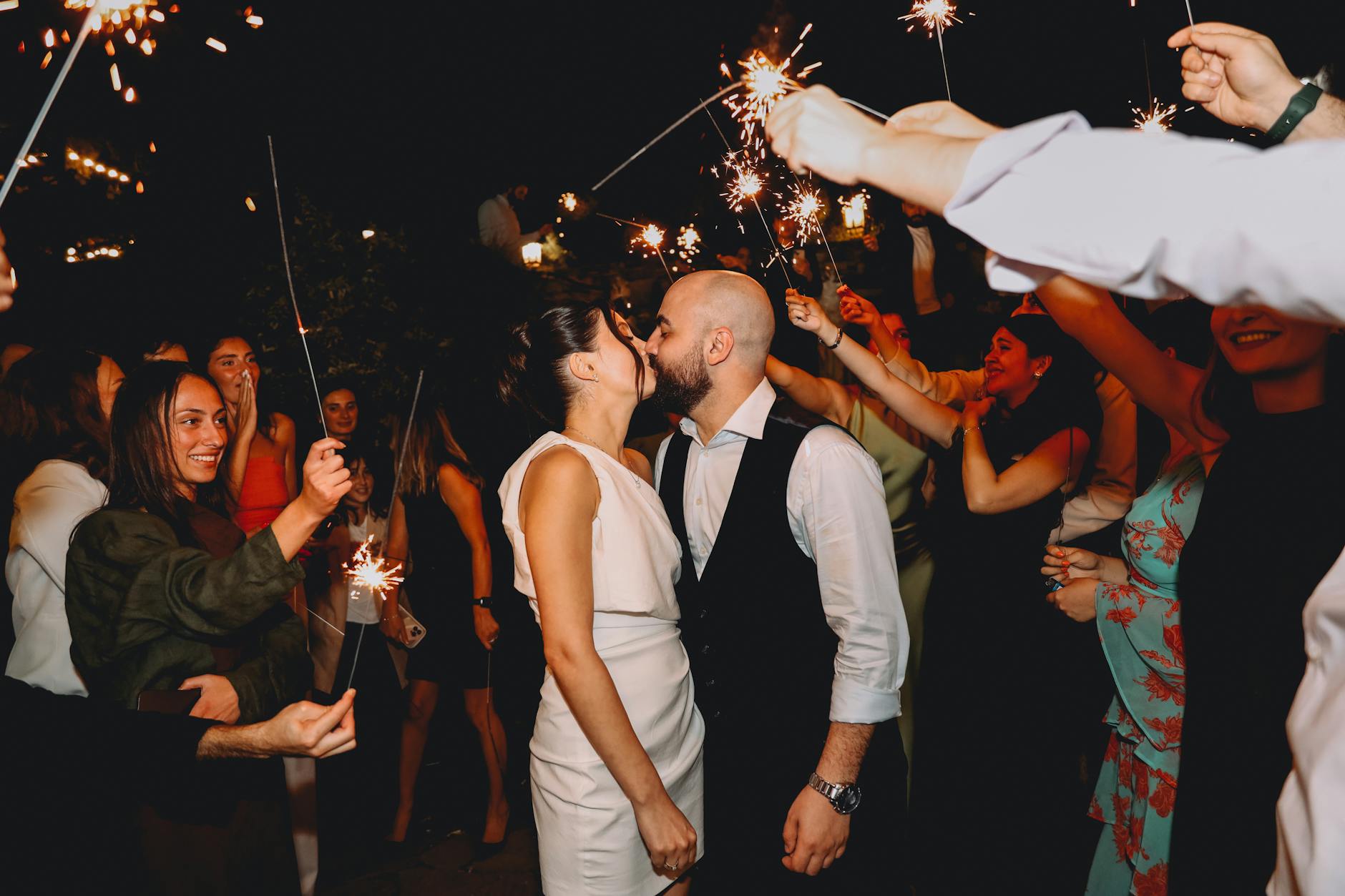 Wedding sparkler send-off ideas — guests forming a double tunnel of lit sparklers